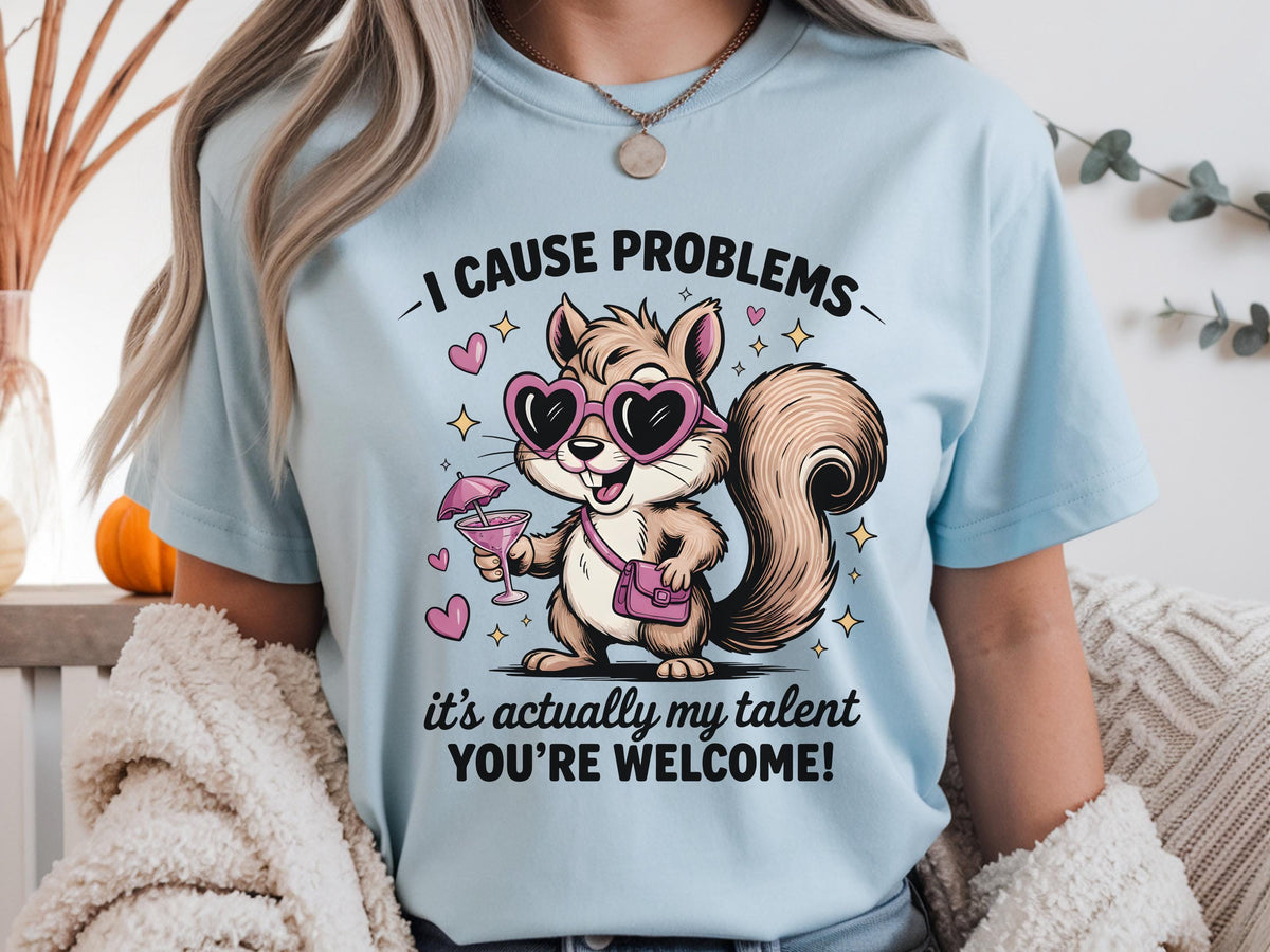 Funny squirrel graphic t-shirt with playful quote “I cause problems it’s actually my talent,” featuring cartoon squirrel with sunglasses and cocktail, worn as a casual summer outfit.