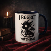 Cute edgy dragon mug with bold “I regret nothing” quote, gothic style coffee cup, dark aesthetic gift idea with moody candle lighting