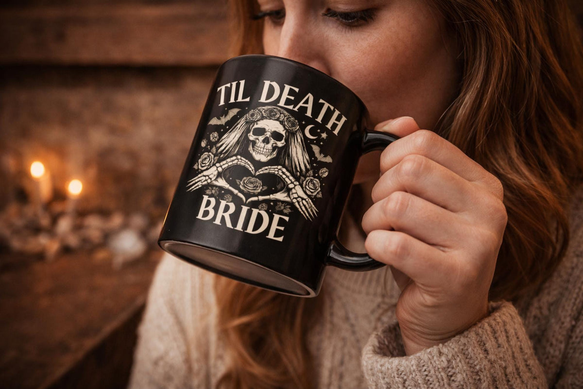 Gothic skeleton bride and groom mug set with til death design on black ceramic mugs styled with candles and dark aesthetic background