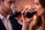 Romantic glassware with personalized lettering placed on a wooden surface with soft lighting