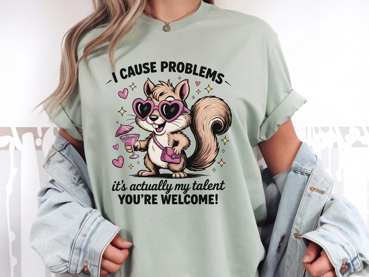 Funny squirrel graphic t-shirt with playful quote “I cause problems it’s actually my talent,” featuring cartoon squirrel with sunglasses and cocktail, worn as a casual summer outfit.