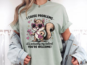 Funny squirrel graphic t-shirt with playful quote “I cause problems it’s actually my talent,” featuring cartoon squirrel with sunglasses and cocktail, worn as a casual summer outfit.