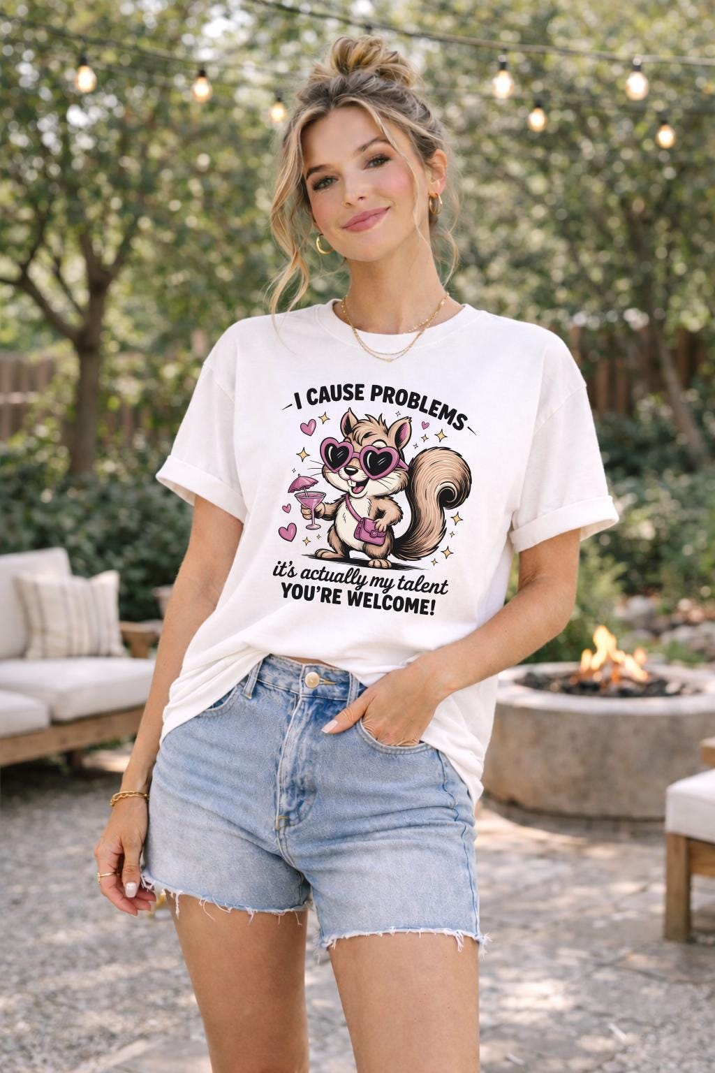 Funny squirrel graphic t-shirt with playful quote “I cause problems it’s actually my talent,” featuring cartoon squirrel with sunglasses and cocktail, worn as a casual summer outfit.
