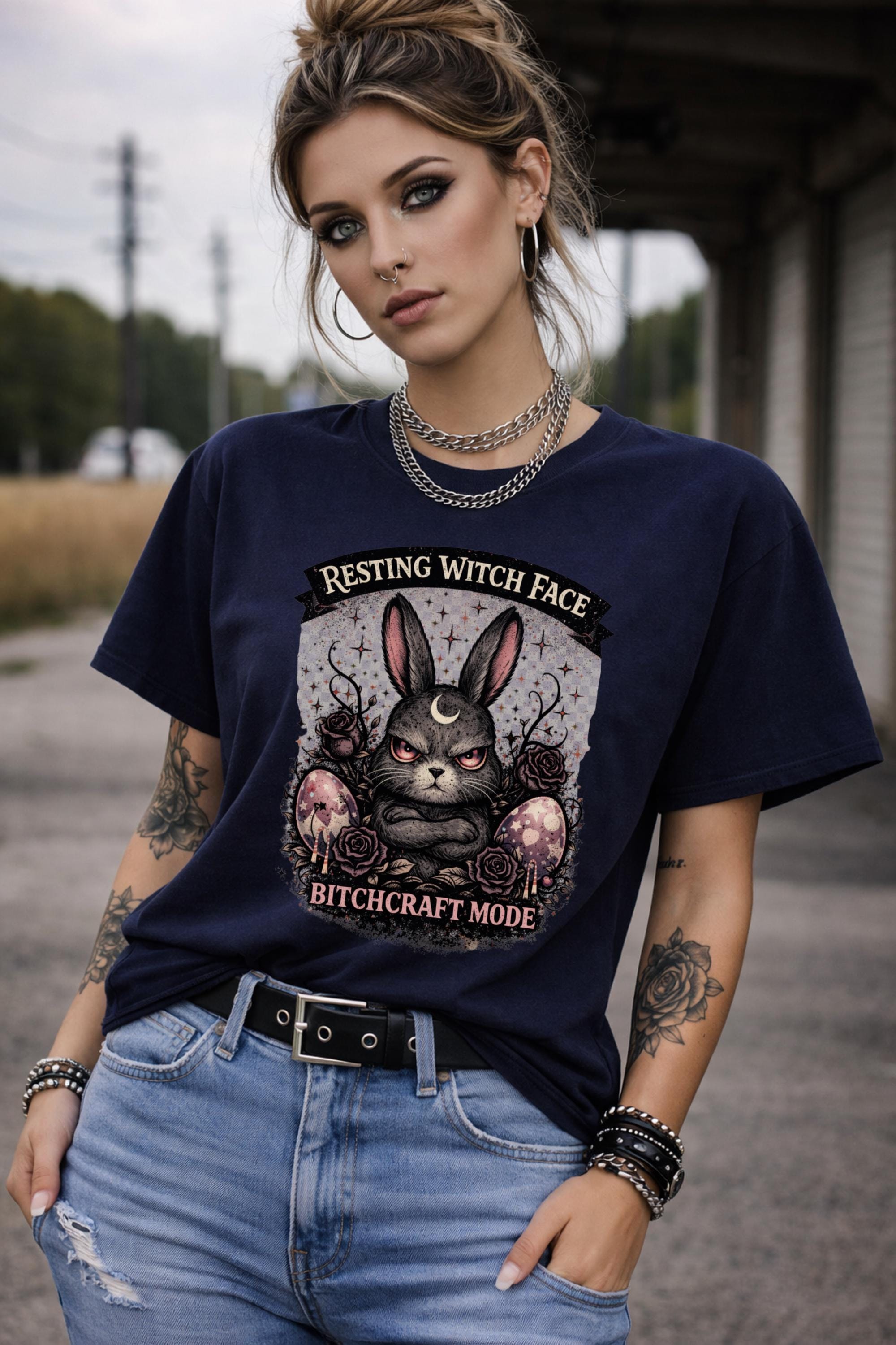 Woman wearing black gothic bunny graphic t-shirt with text Resting Witch Face Bitchcraft Mode styled with denim jeans and layered jewelry