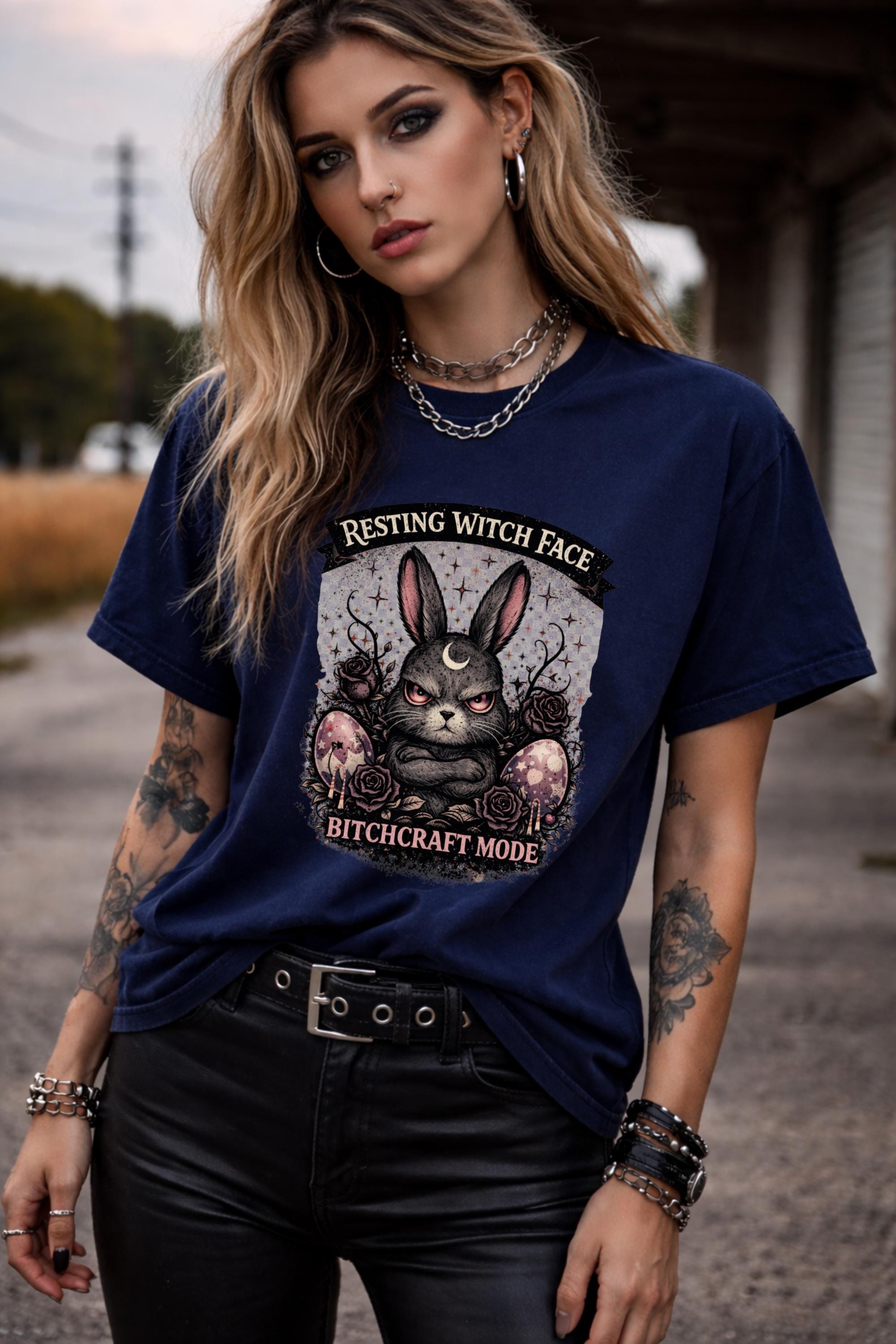 Woman wearing black gothic bunny graphic t-shirt with text Resting Witch Face Bitchcraft Mode styled with denim jeans and layered jewelry