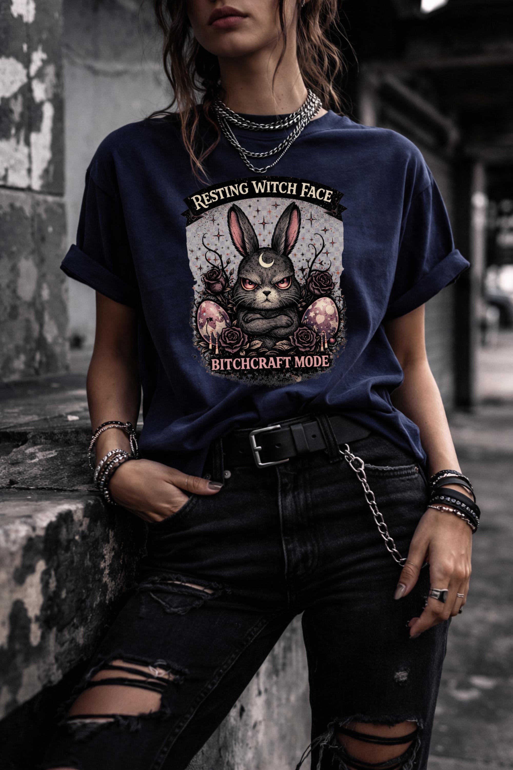 Woman wearing black gothic bunny graphic t-shirt with text Resting Witch Face Bitchcraft Mode styled with denim jeans and layered jewelry