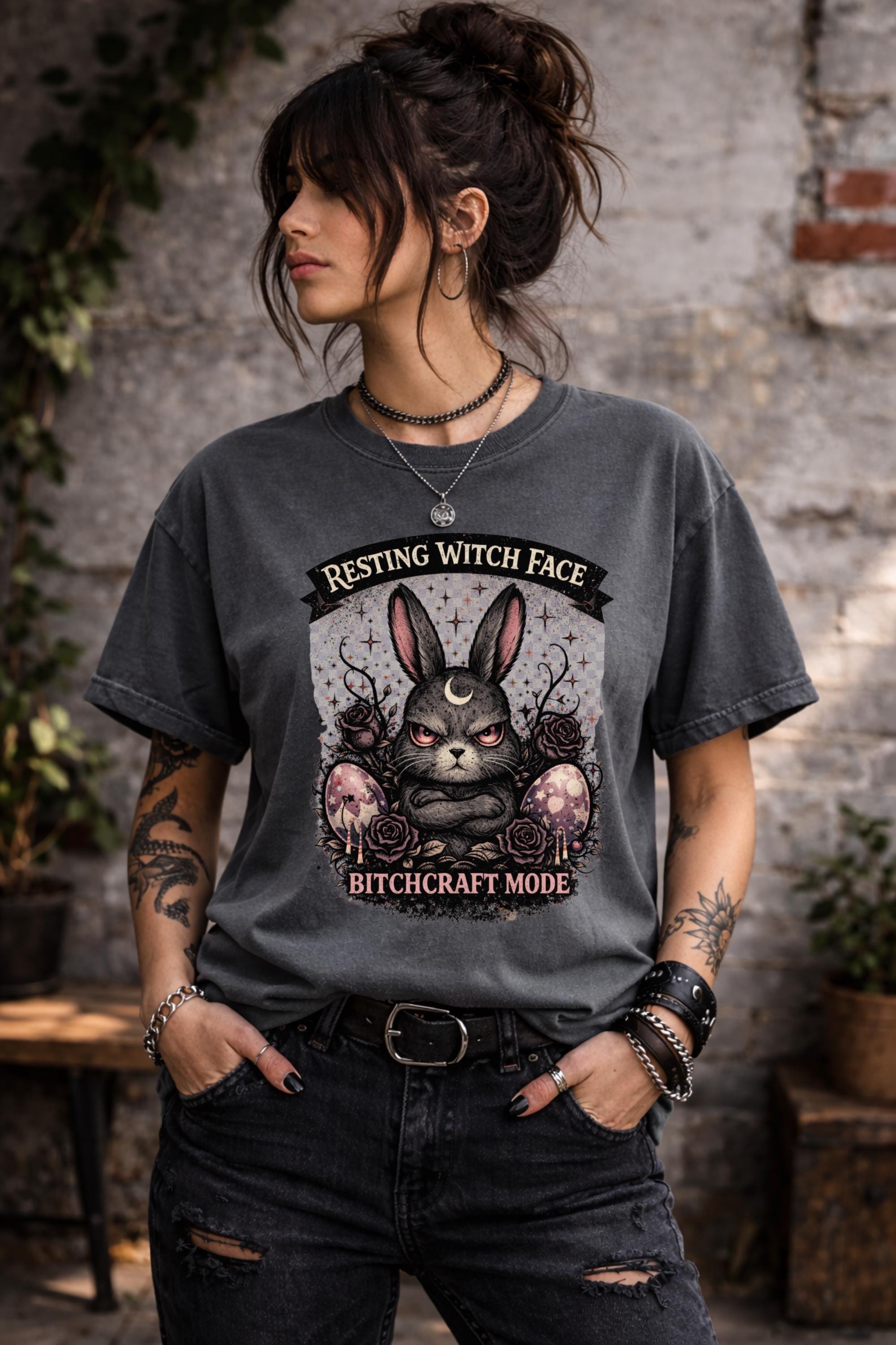 Woman wearing black gothic bunny graphic t-shirt with text Resting Witch Face Bitchcraft Mode styled with denim jeans and layered jewelry