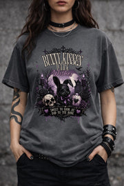 Woman wearing dark gothic bunny graphic t-shirt with text Bunny Kisses Dark Wishes Sweet To Look At Bad To The Bone styled with black jeans