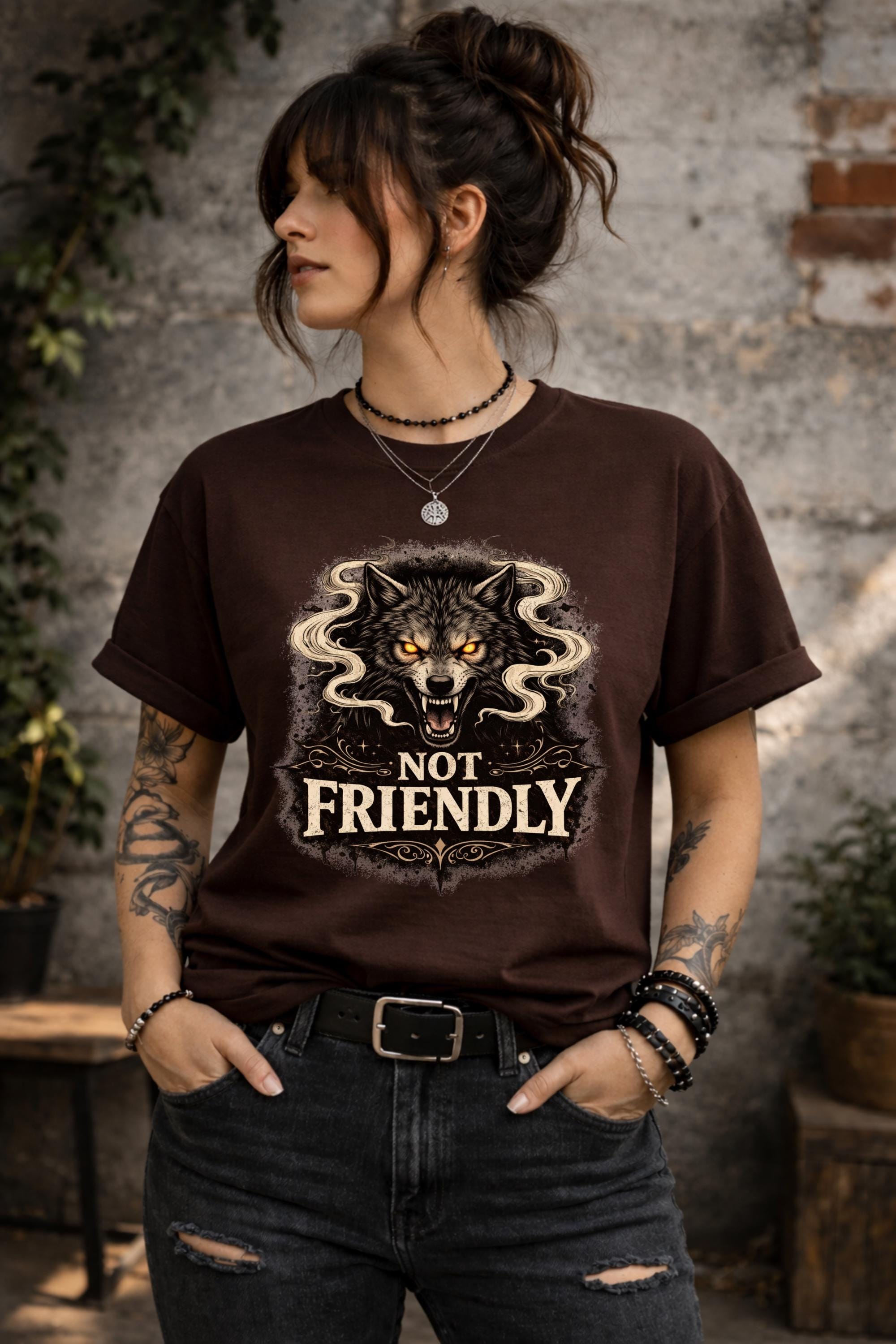 Graphic t-shirt featuring snarling wolf with glowing eyes and “Not Friendly” text, worn by model on beach with casual summer outfit