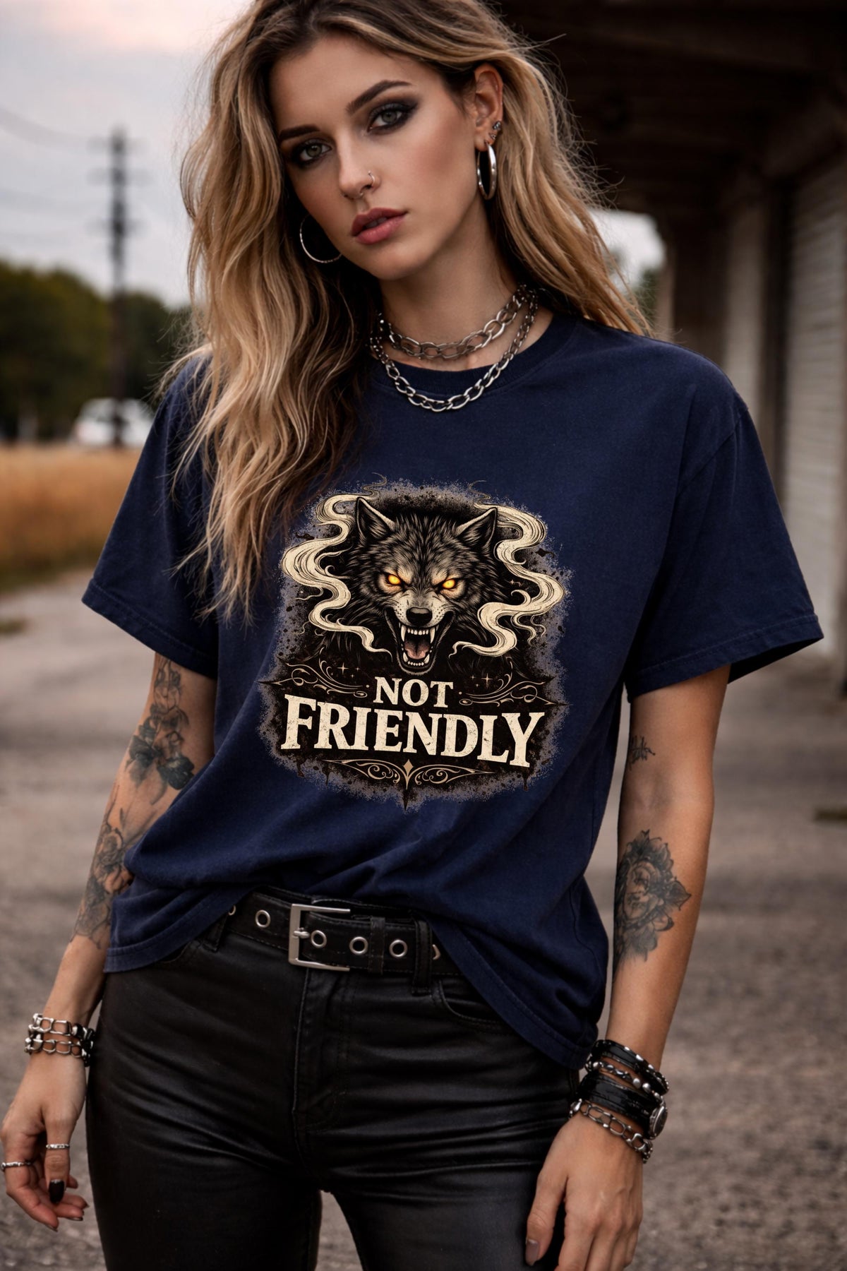 Graphic t-shirt featuring snarling wolf with glowing eyes and “Not Friendly” text, worn by model on beach with casual summer outfit