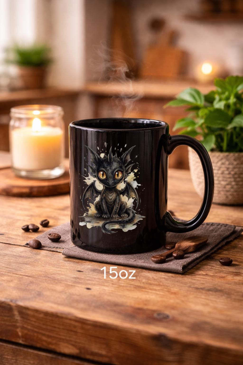 Black ceramic 15oz mug featuring cute watercolor dragon with glowing eyes, styled on rustic wood table with candle, coffee beans, and cozy kitchen background