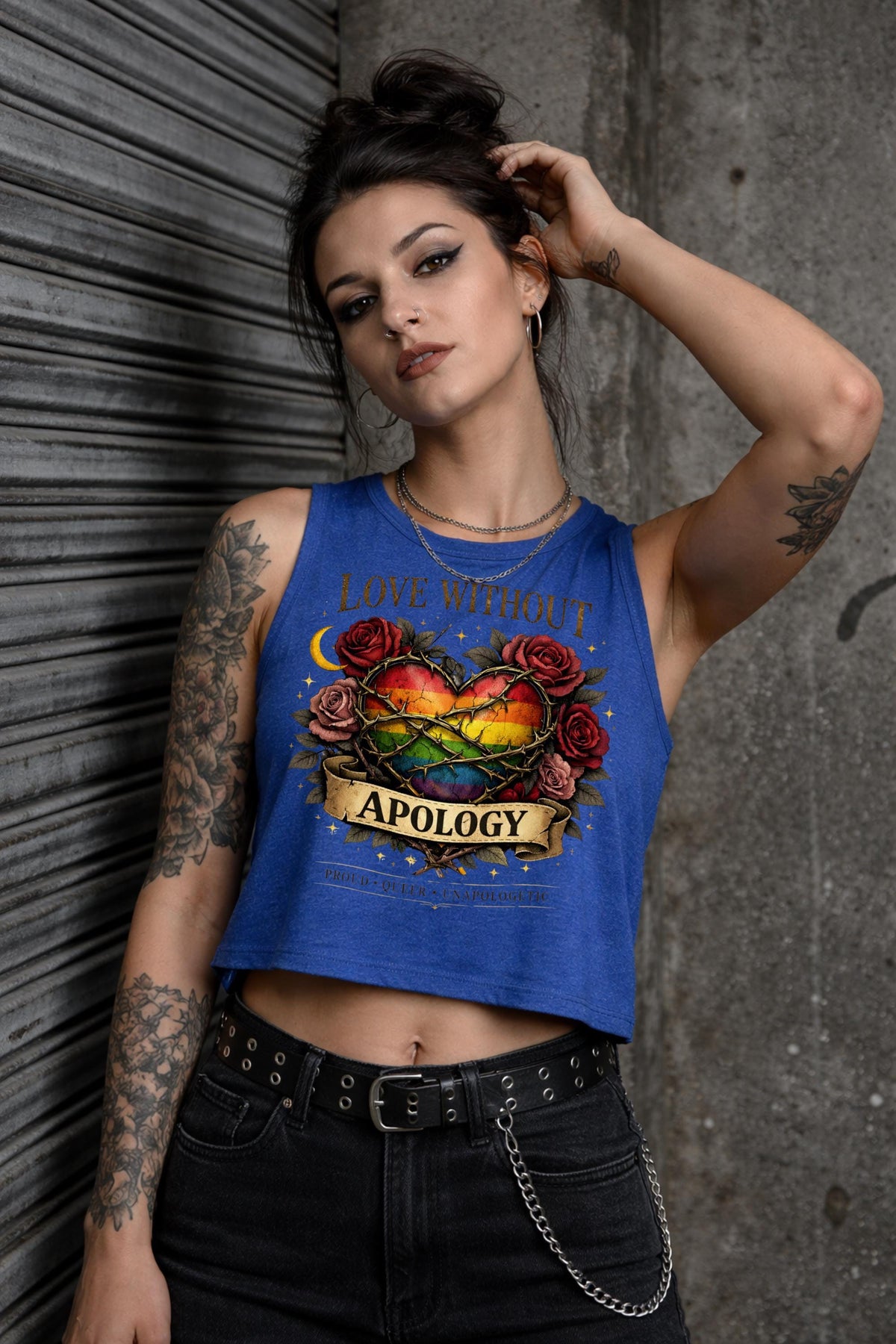 Bella Canvas women’s cropped tank top featuring rainbow heart with roses and “Love Without Apology” text, styled on model with edgy streetwear aesthetic