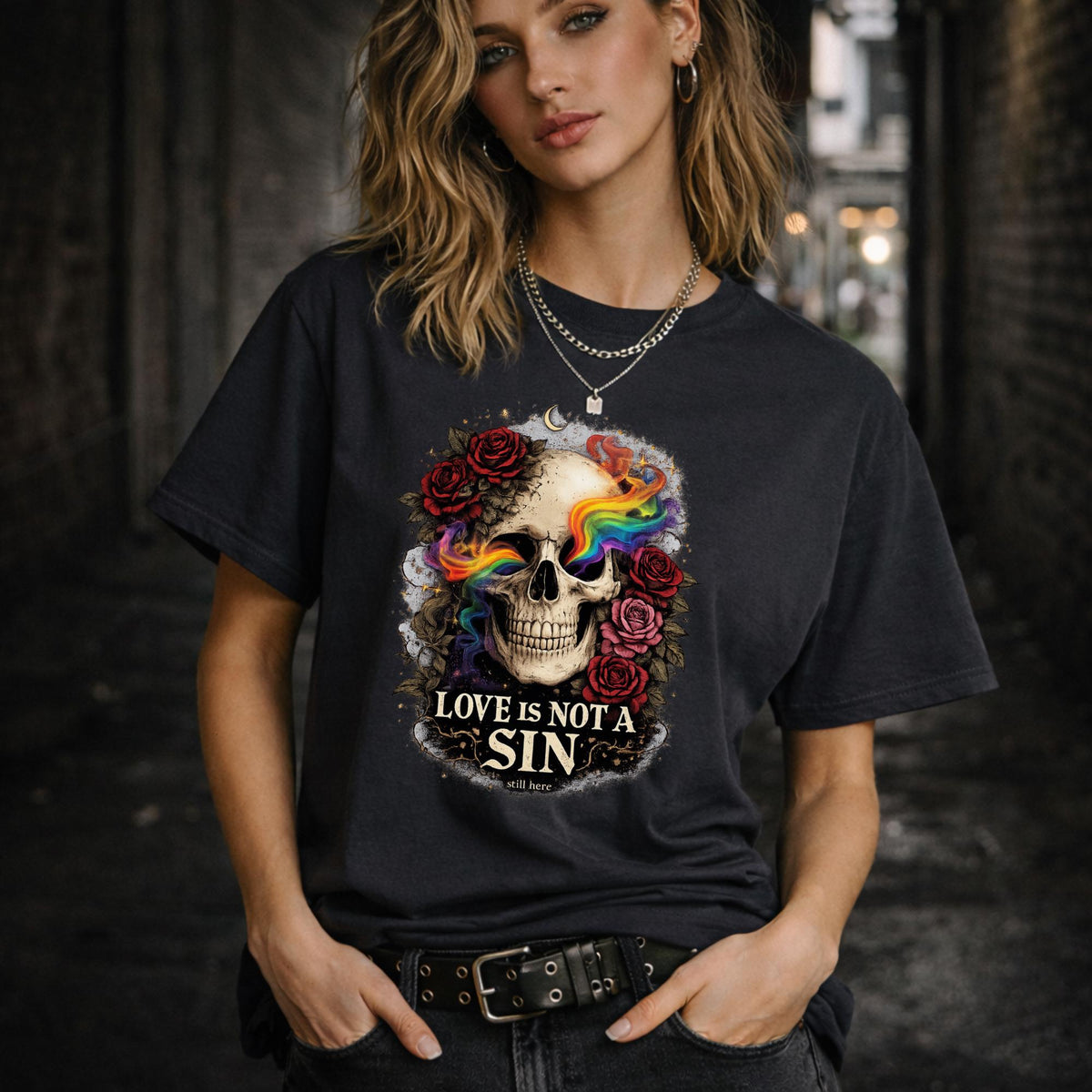 Graphic t-shirt featuring skull with rainbow accents and roses with “Love Is Not a Sin” text, styled on model with edgy alternative streetwear aesthetic