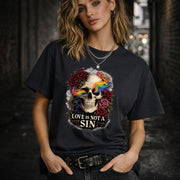 Graphic t-shirt featuring skull with rainbow accents and roses with “Love Is Not a Sin” text, styled on model with edgy alternative streetwear aesthetic