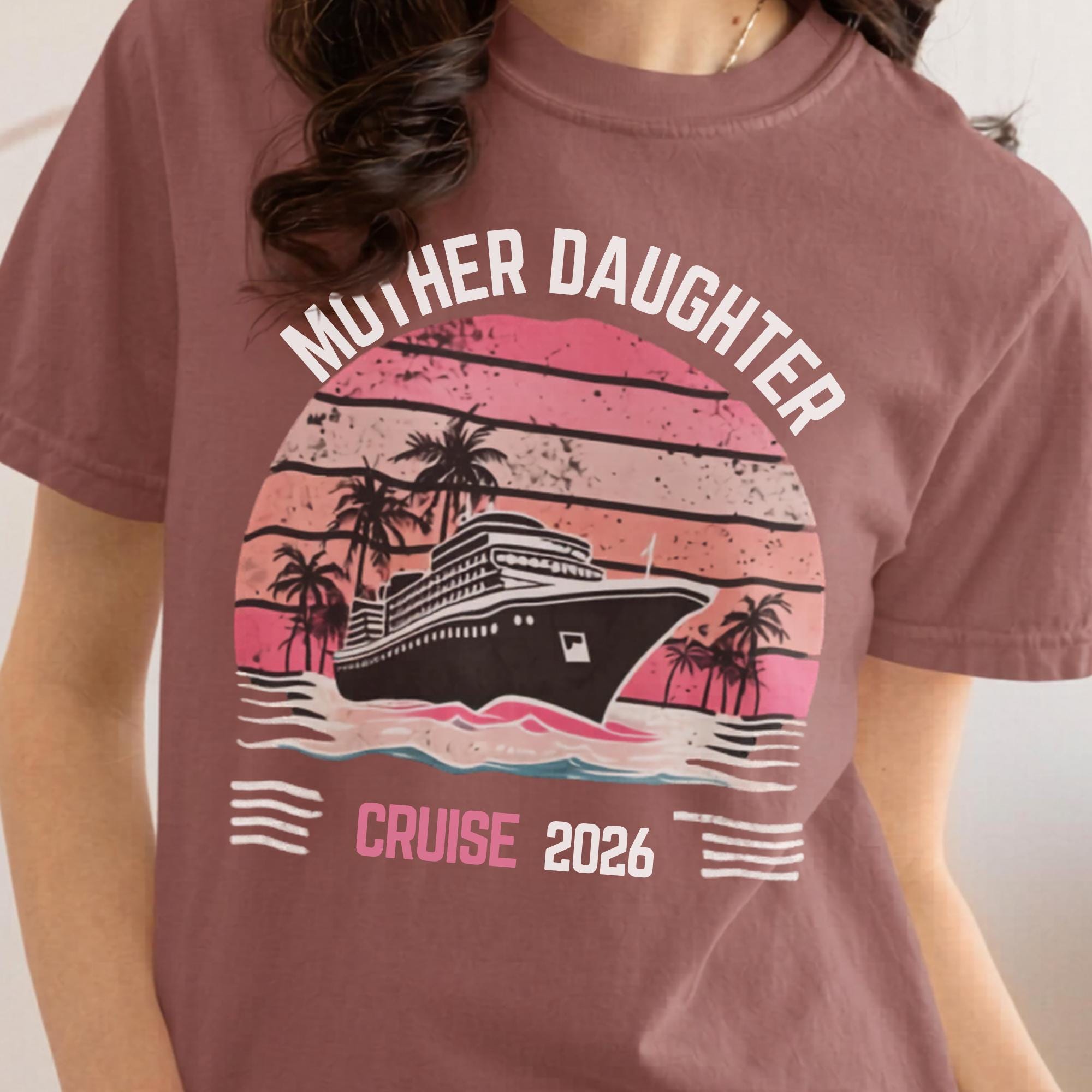 Woman wearing a Brick Comfort Colors t-shirt featuring a retro Mother Daughter Cruise 2026 design with a vintage sunset, palm trees, and cruise ship graphic
