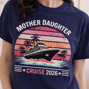 Woman wearing a True Navy Comfort Colors t-shirt featuring a retro Mother Daughter Cruise 2026 design with a vintage sunset, palm trees, and cruise ship graphic