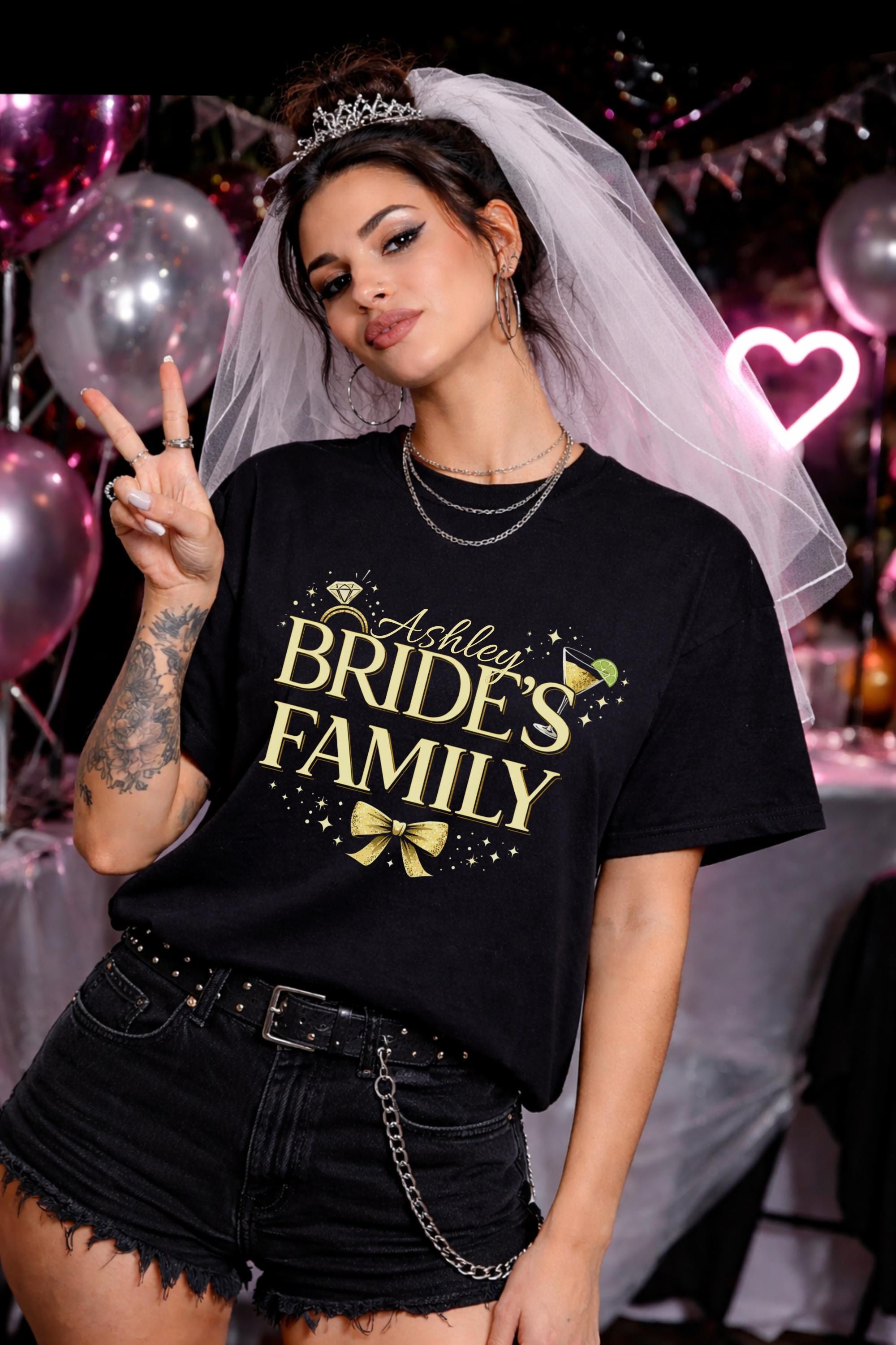 Brides family bachelorette party shirt with custom name Ashley, black tee with gold text, cocktail and bow graphic, bridal party outfit