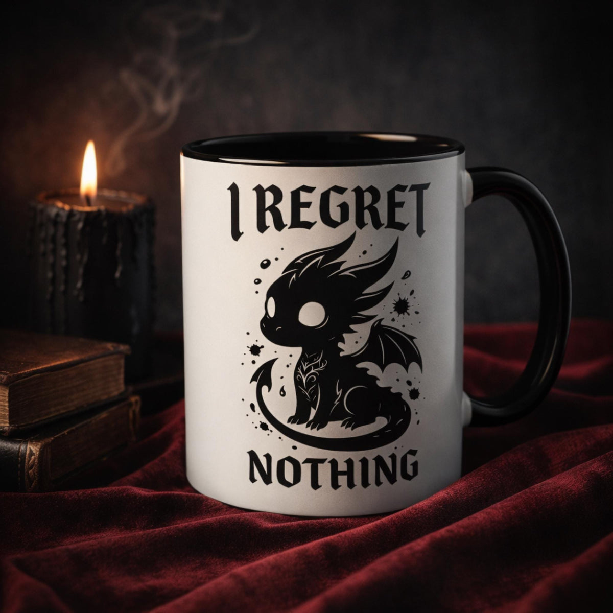 Gothic dragon coffee mug with “I regret nothing” text, black and white ceramic mug with black handle, dark academia aesthetic setup with candle and books