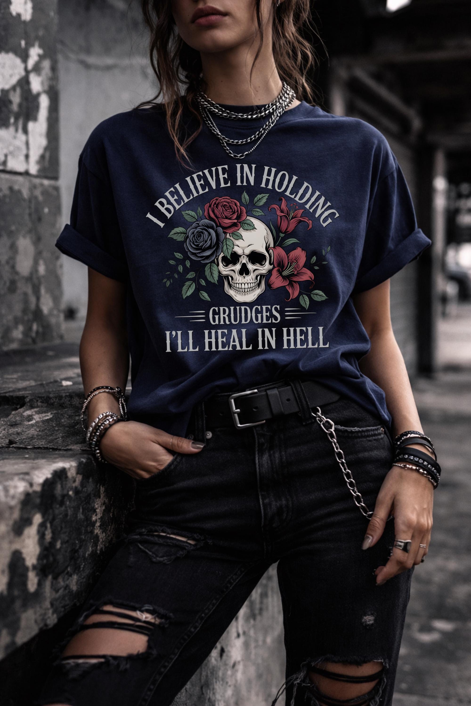 Woman wearing navy gothic skull and roses t-shirt with text “I believe in holding grudges I’ll heal in hell”, dark aesthetic grunge outfit
