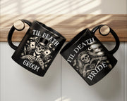 Black gothic coffee mugs featuring skeleton bride and groom artwork stacked together on wooden table with candlelight