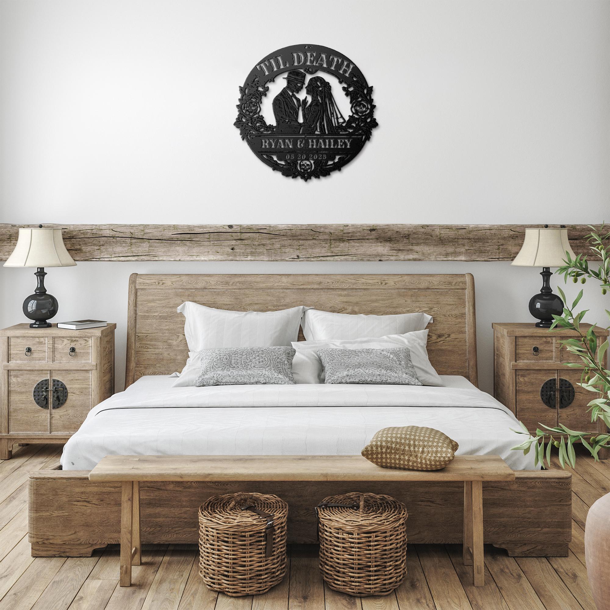 Black metal decor sign with bride and groom design mounted above wooden table with warm candlelit atmosphere