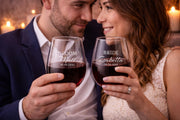 Romantic glassware with personalized lettering placed on a wooden surface with soft lighting