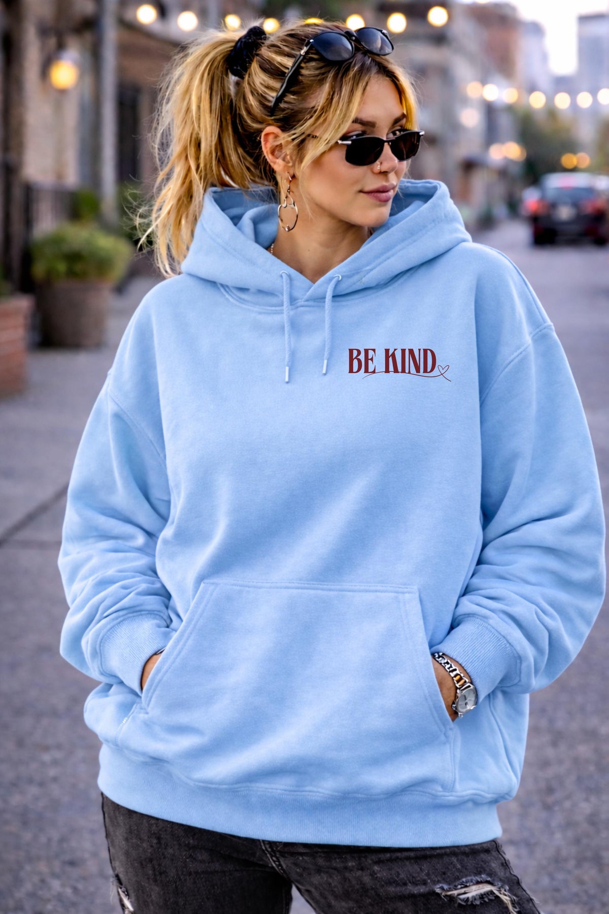 Inspirational hoodie with “Be Kind” message on the front, styled in an everyday lifestyle setting