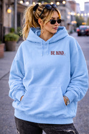 Inspirational hoodie with “Be Kind” message on the front, styled in an everyday lifestyle setting