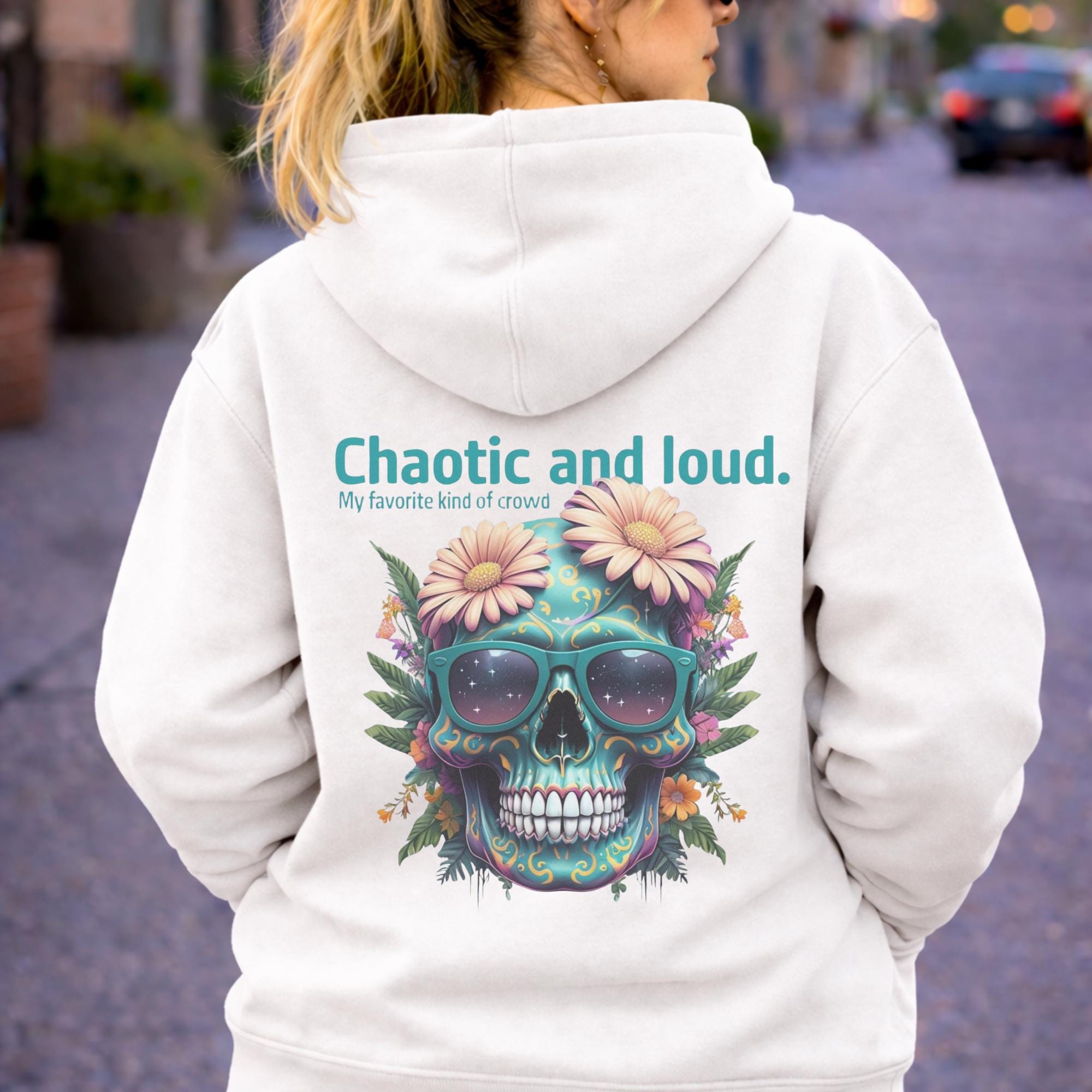 Back view of woman wearing a white Premium Pullover Hoodie Cotton Heritage M2580 featuring a colorful floral skull with sunglasses design and the text “Chaotic and loud, my favorite kind of crowd” printed on the back