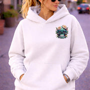 Front view of woman wearing a Premium Pullover Hoodie Cotton Heritage M2580 with a small colorful floral skull with sunglasses design on the chest