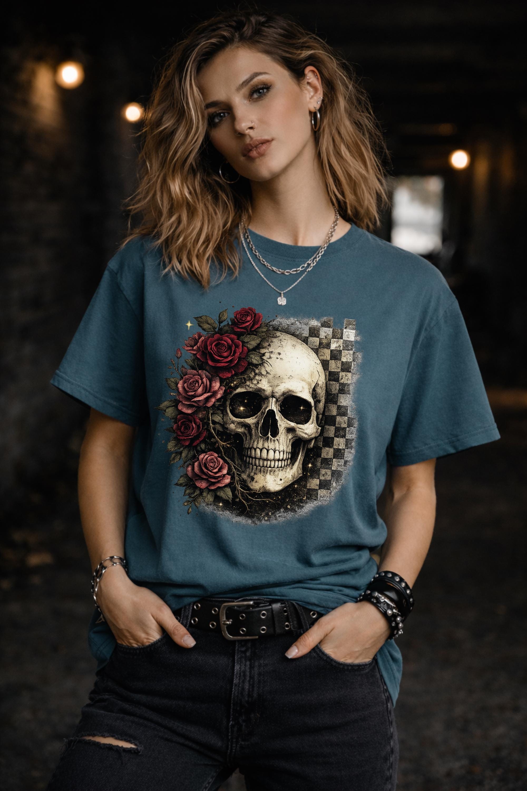 Comfort Colors 1717 t-shirt in blue spruce featuring a gothic skull with red roses and checkerboard background, worn by model outdoors