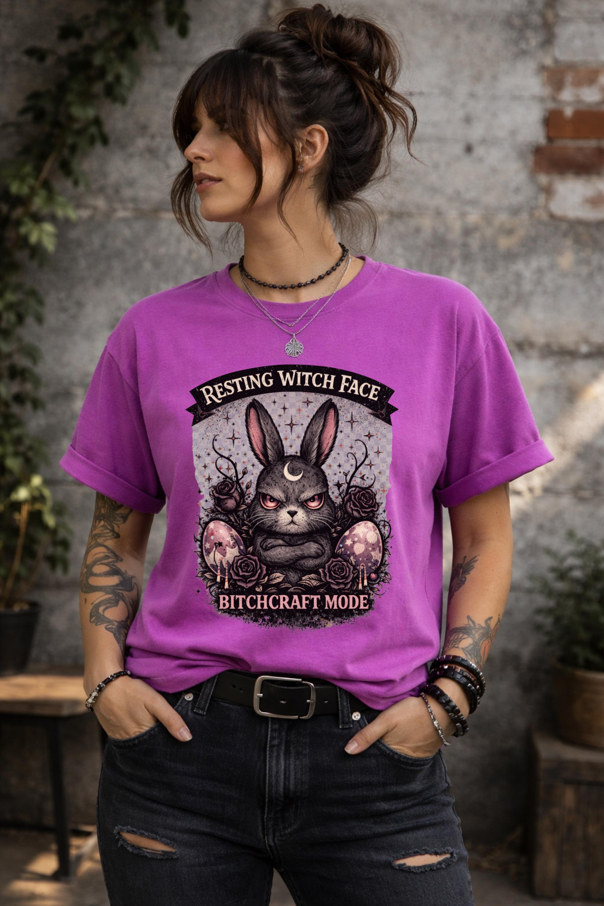 Woman wearing black gothic bunny graphic t-shirt with text Resting Witch Face Bitchcraft Mode styled with denim jeans and layered jewelry