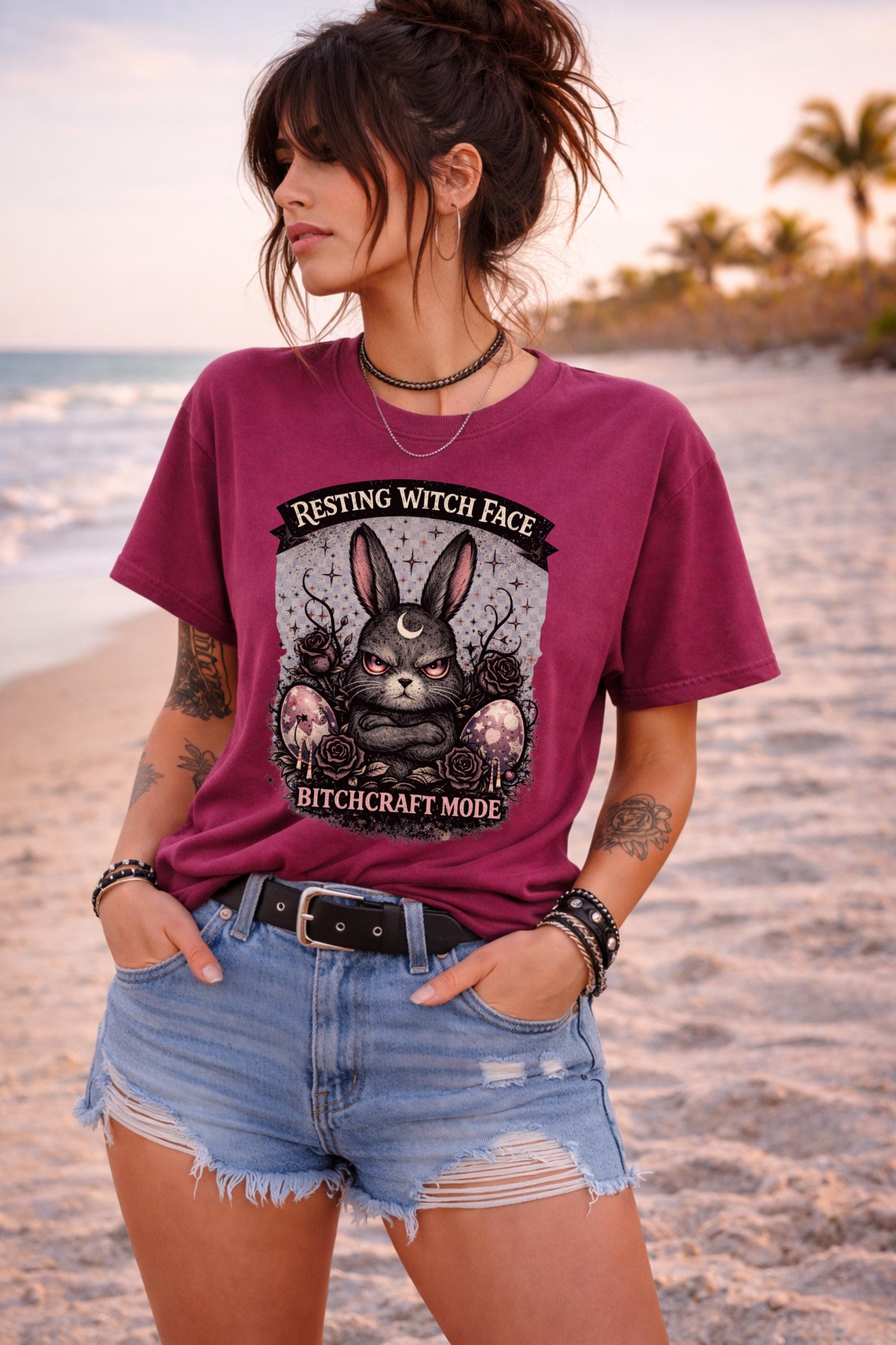 Woman wearing black gothic bunny graphic t-shirt with text Resting Witch Face Bitchcraft Mode styled with denim shorts and layered jewelry
