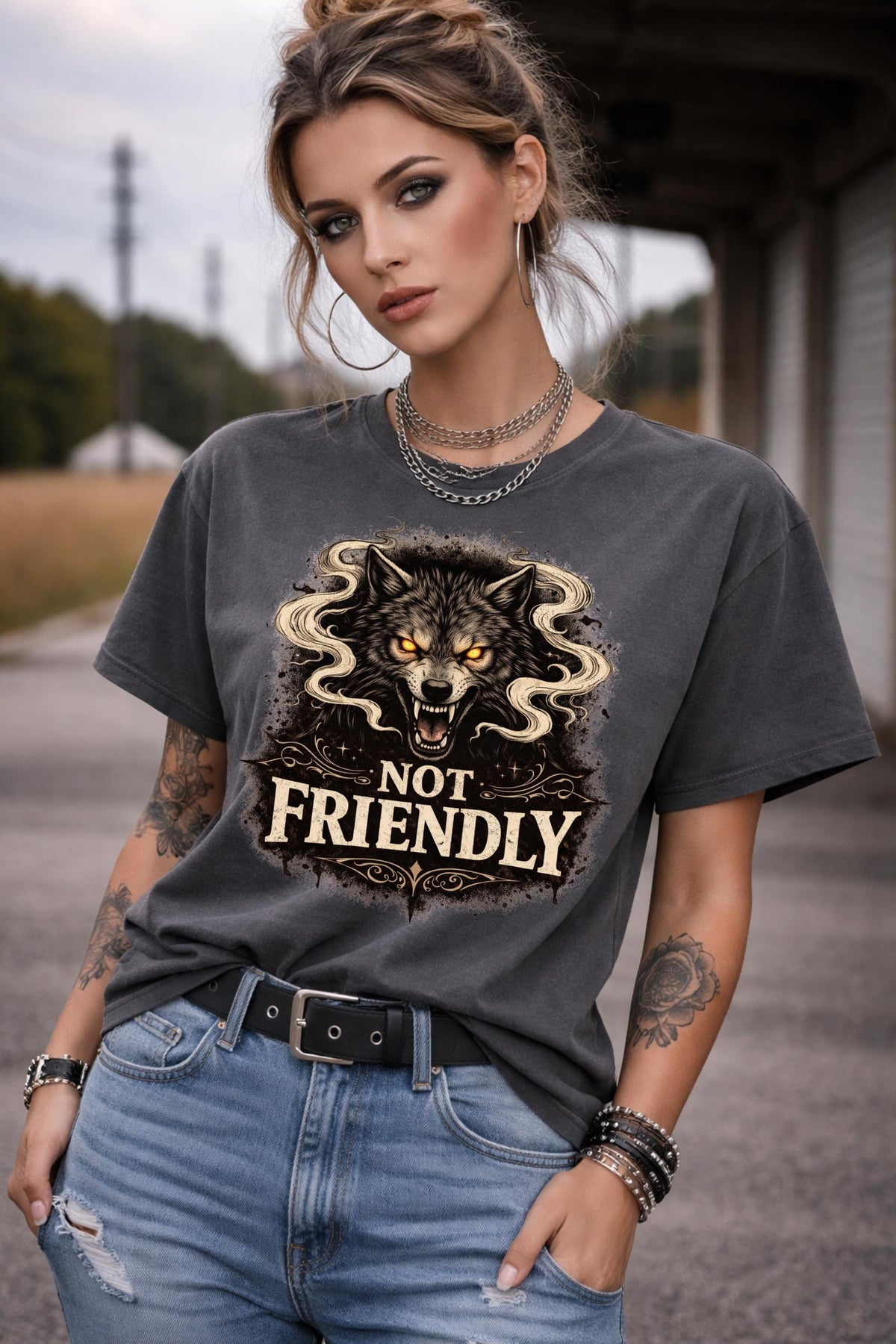 Graphic t-shirt featuring snarling wolf with glowing eyes and “Not Friendly” text, worn by model on beach with casual summer outfit