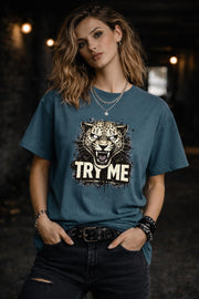 Graphic t-shirt featuring fierce leopard with bold “Try Me” text, styled on model with edgy casual outfit in outdoor setting
