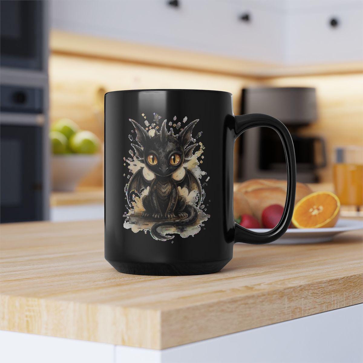 Black ceramic 11oz mug featuring cute watercolor dragon with glowing eyes, styled on rustic wood table with candle, coffee beans, and cozy kitchen background