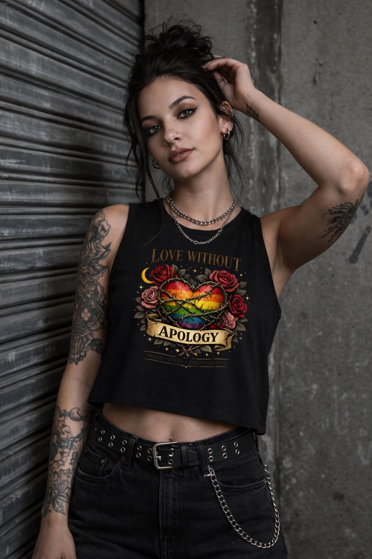 Bella Canvas women’s cropped tank top featuring rainbow heart with roses and “Love Without Apology” text, styled on model with edgy streetwear aesthetic