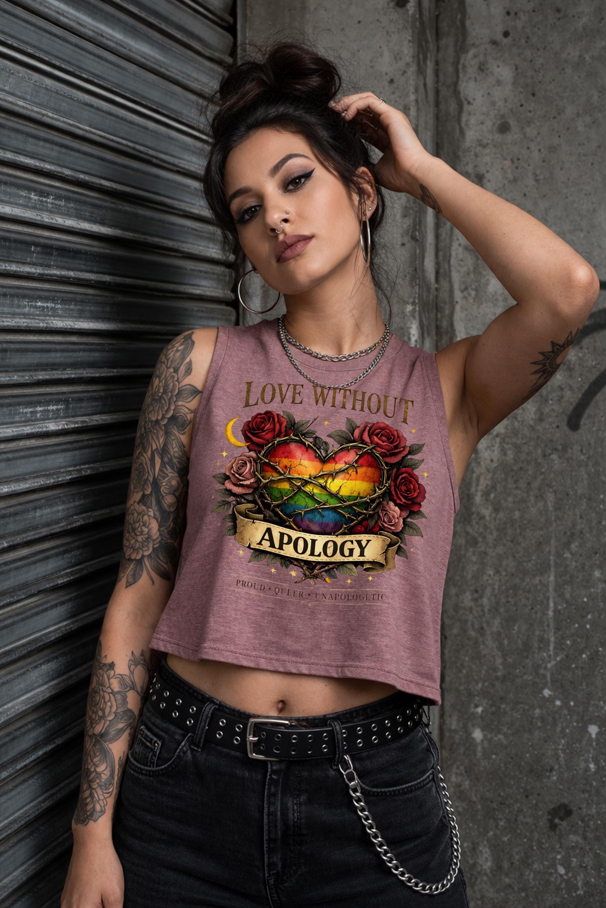 Bella Canvas women’s cropped tank top featuring rainbow heart with roses and “Love Without Apology” text, styled on model with edgy streetwear aesthetic