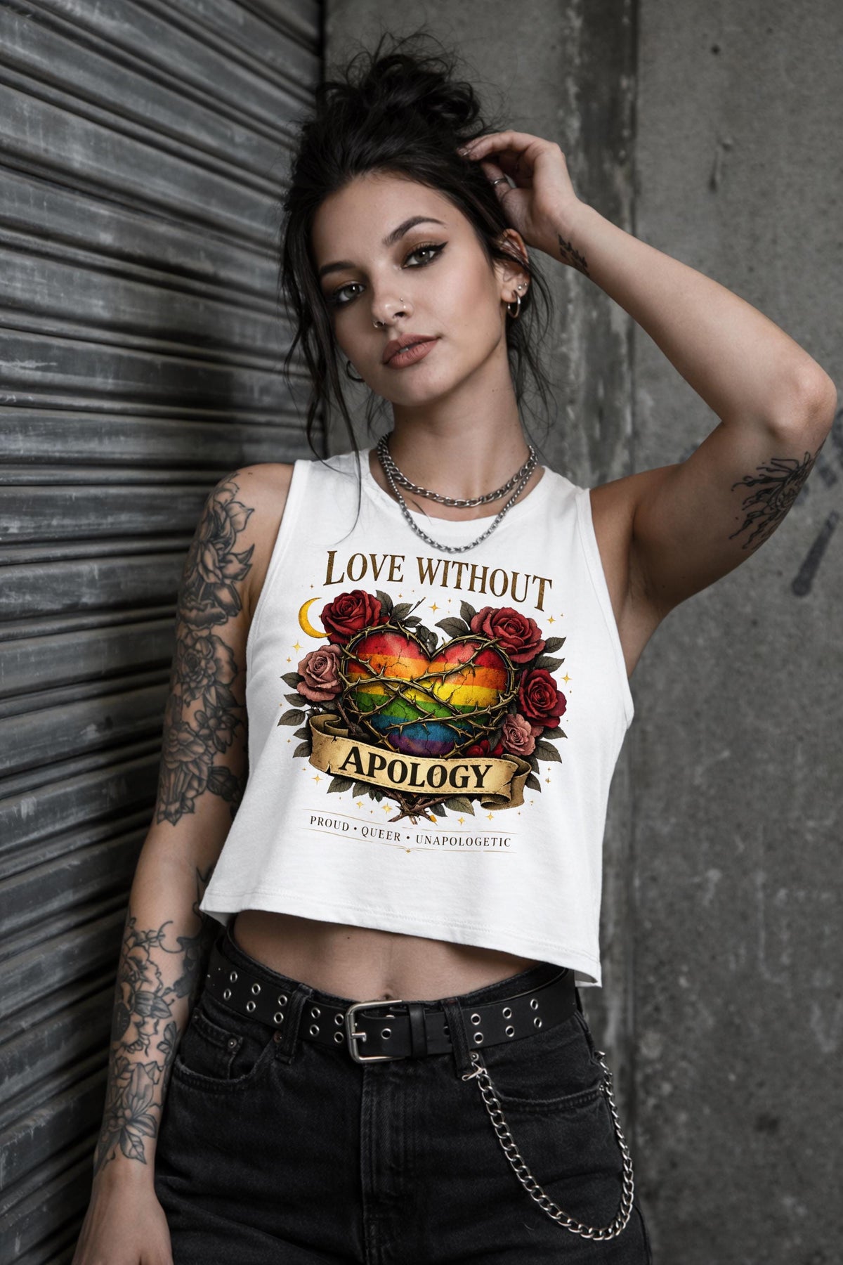 Bella Canvas women’s cropped tank top featuring rainbow heart with roses and “Love Without Apology” text, styled on model with edgy streetwear aesthetic
