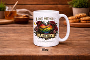 White ceramic 15oz mug featuring rainbow heart with roses and “Love Without Apology” text, styled on rustic kitchen table with muffins and coffee background