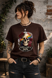 Graphic t-shirt featuring skull with rainbow accents and roses with “Love Is Not a Sin” text, styled on model with edgy alternative streetwear aesthetic