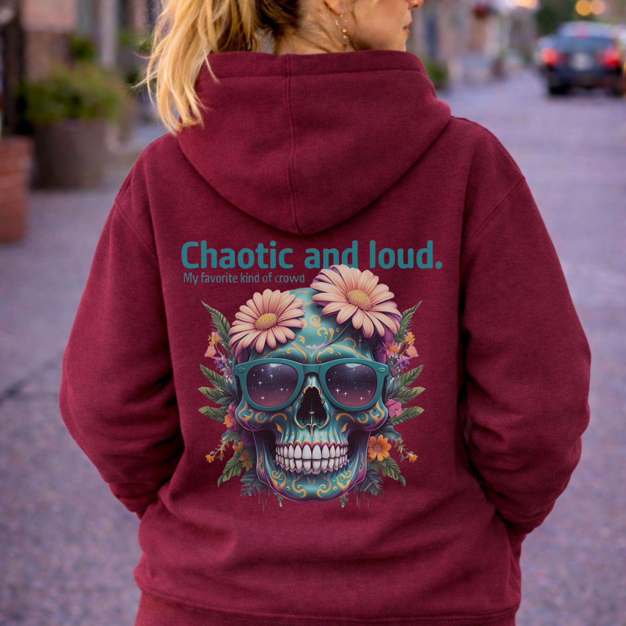 Back view of woman wearing a red Premium Pullover Hoodie Cotton Heritage M2580 featuring a colorful floral skull with sunglasses design and the text “Chaotic and loud, my favorite kind of crowd” printed on the back