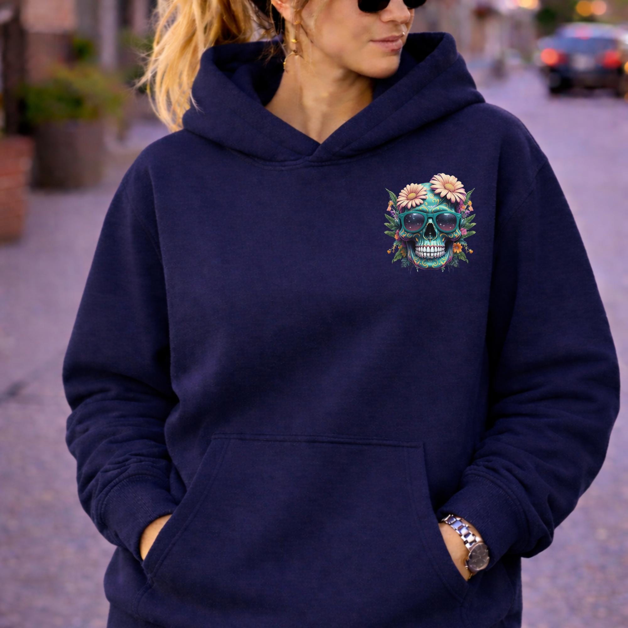 Front view of woman wearing a navy Premium Pullover Hoodie Cotton Heritage M2580 with a small colorful floral skull with sunglasses design on the chest