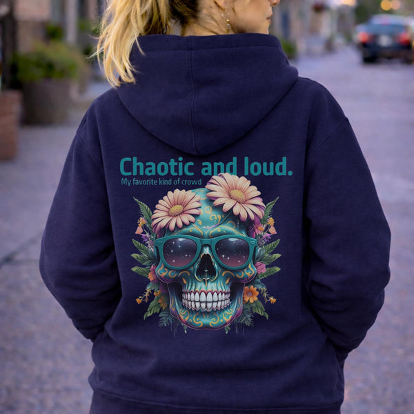 Back view of woman wearing a navy Premium Pullover Hoodie Cotton Heritage M2580 featuring a colorful floral skull with sunglasses design and the text “Chaotic and loud, my favorite kind of crowd” printed on the back