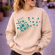 Woman wearing sand crewneck sweatshirt in casual outdoor setting with relaxed fit and soft fabric, styled with black jeans and sunglasses