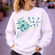 Woman wearing white crewneck sweatshirt in casual outdoor setting with relaxed fit and soft fabric, styled with black jeans and sunglasses