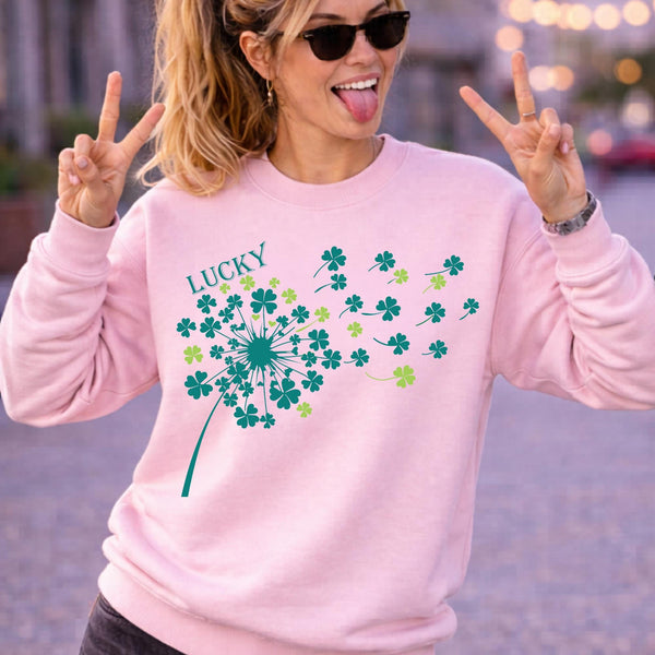 Woman wearing light pink crewneck sweatshirt in casual outdoor setting with relaxed fit and soft fabric, styled with black jeans and sunglasses