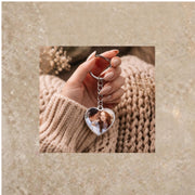 Silver heart keychain with romantic couple photo on cozy styled background