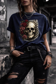 Comfort Colors 1717 t-shirt in true navy featuring a gothic skull with red roses and checkerboard background, worn by model outdoors