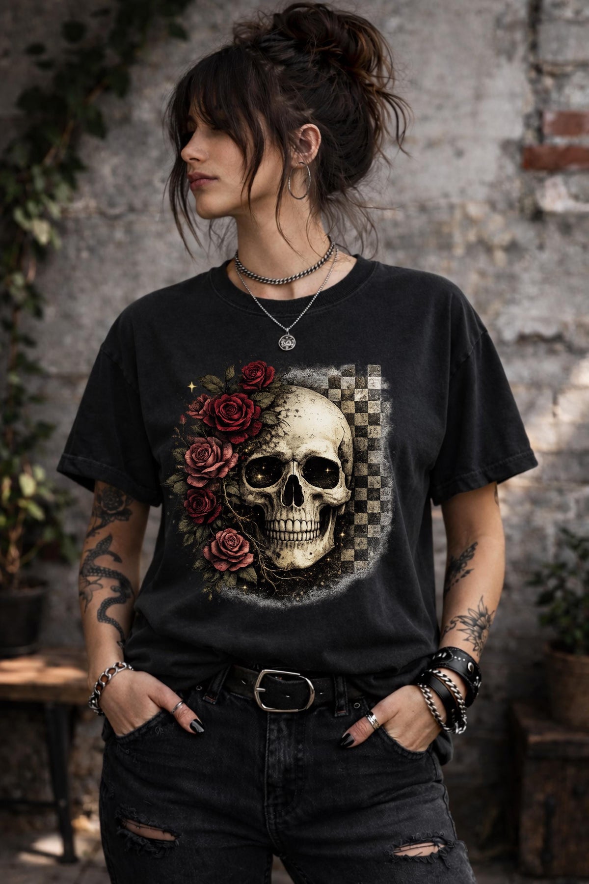 Comfort Colors 1717 t-shirt in black featuring a gothic skull with red roses and checkerboard background, worn by model outdoors